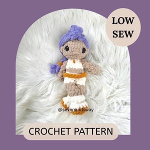 May include: A handmade crochet doll with a purple turban, tan skin, and a white and orange outfit. The doll is on a white fluffy surface. The text "LOW SEW" and "CROCHET PATTERN" are also visible.
