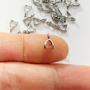 May include: Silver-toned metal jump rings, also known as bail rings, are a popular jewelry making supply. These rings are used to attach charms, pendants, and other jewelry components to necklaces, bracelets, and earrings.