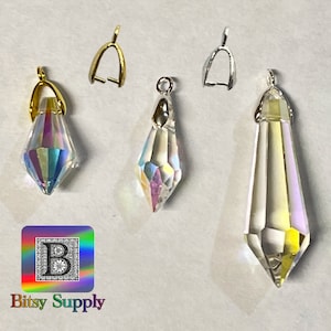 May include: Four crystal teardrop pendants with silver and gold bail settings. The pendants are clear and iridescent. The pendants are for jewelry making.