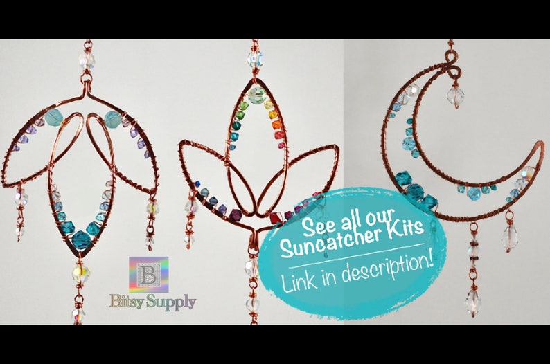 May include: Three copper wire suncatchers with colorful beads and crystals. The suncatchers are shaped like a leaf, a lotus flower, and a crescent moon. The text "See all our Suncatcher Kits Link in description!" is written in white on a blue background.