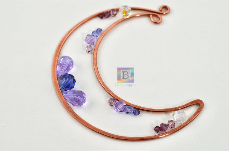 May include: Copper wire crescent moon shape with purple, blue, and clear glass beads attached.