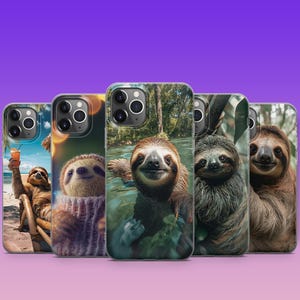 May include: Four different phone cases featuring sloths in various poses. The cases are clear and show the phone's camera lens. The sloths are in a variety of colors, including brown, gray, and white. The cases are all designed to fit an iPhone.