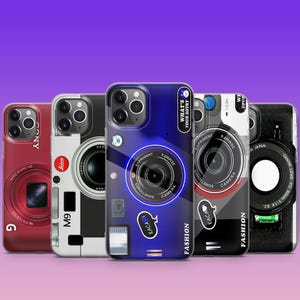 May include: Five different phone cases featuring a vintage camera design. The cases are all black and white with a red, blue, or black accent. The cases have the text "KACA!" and "FASHION" on them. The cases also have the text "WHAT'S YOUR SOTRY" and "EXPRIMENT" on them.