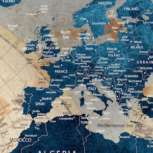 May include: A vintage-style map of Europe with a blue and brown color scheme. The map shows country borders, major cities, and bodies of water. The map is framed with a brown border.