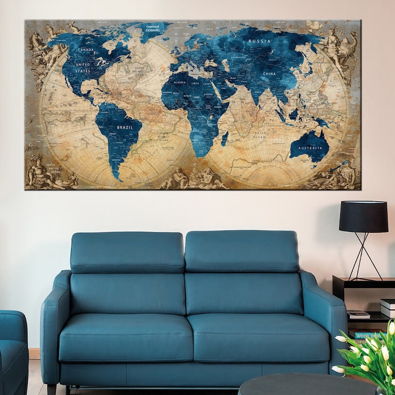 May include: A vintage-style world map with blue oceans and continents in beige and brown tones. The map is framed and hanging on a wall above a blue sofa.