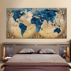 May include: A vintage-style world map with blue oceans and brown landmasses. The map is framed and hanging above a bed with brown bedding.