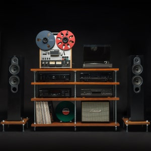 May include: A vintage audio system featuring a reel-to-reel tape player, turntable, amplifier, and speakers. The system is arranged on a wooden shelf unit with a Marshall speaker on the bottom shelf.