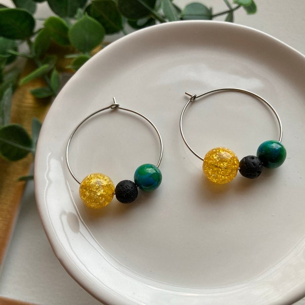 Solar Eclipse beaded hoop earrings! 1-1/4” stainless steel hoops with beads representing Earth, moon, and sun. Solar Eclipse party jewelry.