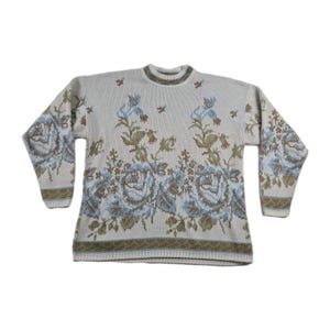 May include: A white ceramic mug with a black handle and the text "But First, Coffee" in a black, bold font. The mug is sitting on a white surface. The mug appears to be 12 ounces.