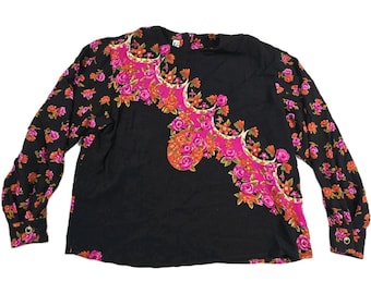 May include: Black long-sleeve shirt with a floral design. The shirt features a pink and orange floral pattern on the front and sleeves. The sleeves have buttoned cuffs. The shirt is made of a soft, comfortable material.