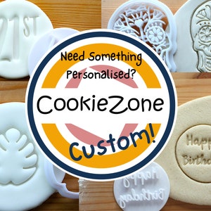 May include: A selection of cookie cutters in different shapes and sizes, including a skull, a tree, a leaf, and a number 21. The cutters are white and are displayed on a wooden surface. A yellow and orange circle with the text "CookieZone Custom!" is in the centre of the image.
