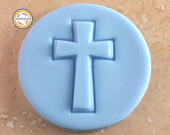 May include: A light blue plastic cookie cutter in the shape of a cross.