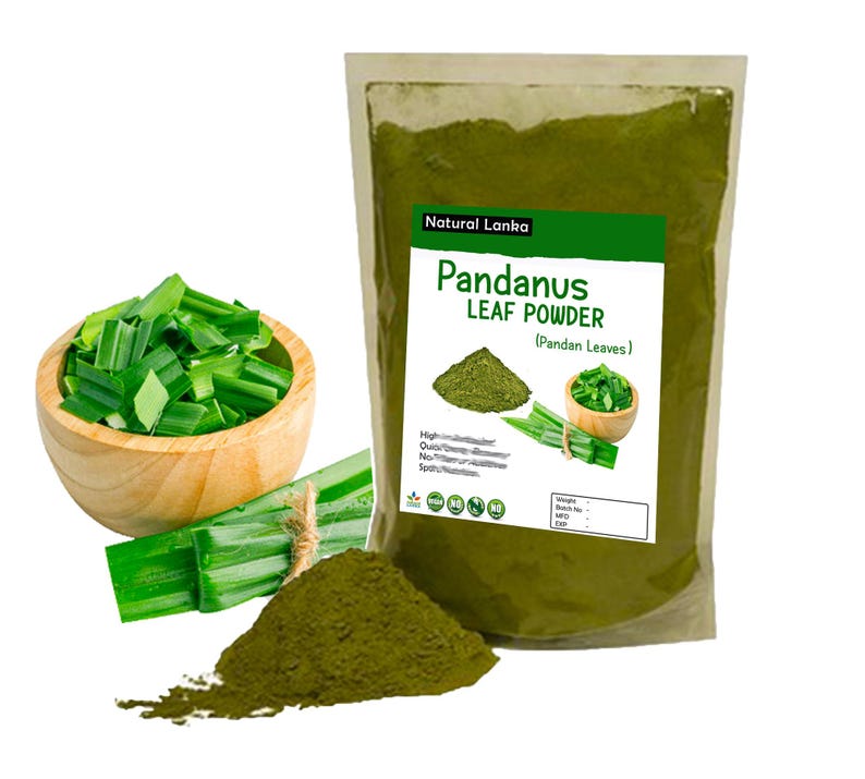 May include: A clear plastic pouch of Natural Lanka Pandanus Leaf Powder with a white label featuring green text, a pile of dark green powder, and images of fresh pandan leaves. Beside it sits a wooden bowl filled with chopped green leaves.