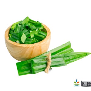 May include: A wooden bowl filled with chopped vibrant green pandan leaves, accompanied by a bundle of fresh, long pandan leaves tied together with a thin piece of natural twine. The leaves feature a smooth texture and a deep green color.