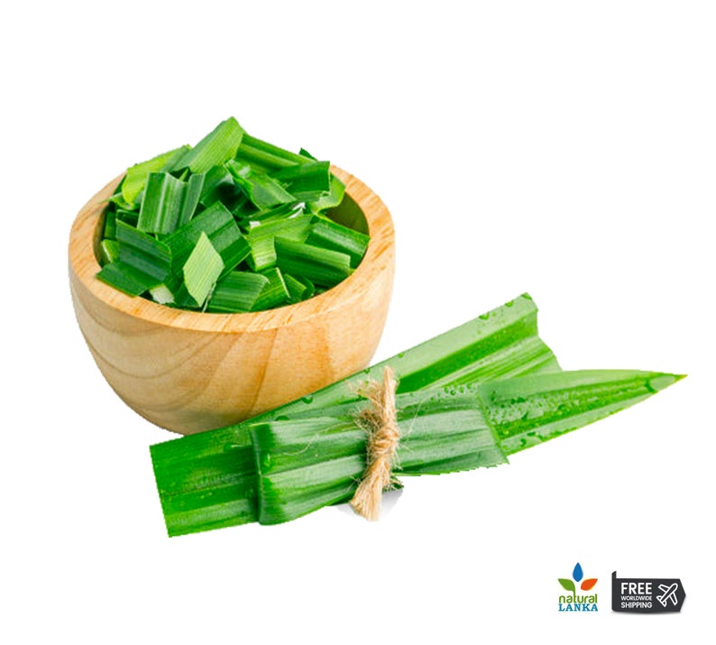May include: A wooden bowl filled with chopped vibrant green pandan leaves, accompanied by a bundle of fresh, long pandan leaves tied together with a thin piece of natural twine. The leaves feature a smooth texture and a deep green color.