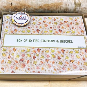 May include: A box containing 10 fire starters and matches, featuring a autumnal leaf design. The box is brown with a white label that reads "Box of 10 Fire Starters & Matches" and "Aflare LLC".