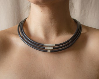 Handmade modern necklace made of silver and caoutchouc. Unique geometrical design.