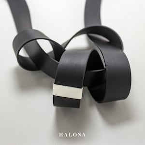 Handmade modern necklace made of silver and caoutchouc. Unique geometrical design.