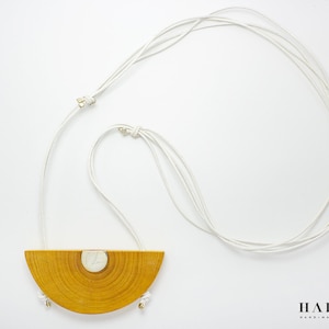 Handmade modern necklace made of silver and leather. Unique geometrical design.