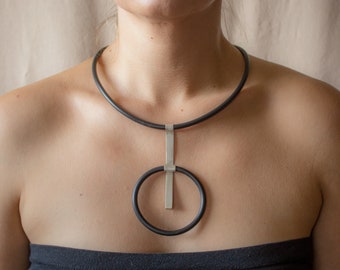 Handmade modern necklace made of silver and caoutchouc. Unique geometrical design.