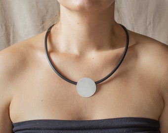 Handmade modern necklace made of silver and caoutchouc. Unique geometrical design