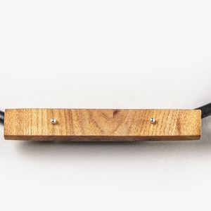Handmade modern necklace made of wood, silver and caoutchouc. Unique geometrical design.