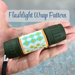 May include: A dark olive green flashlight featuring a central beaded wrap with a geometric pattern in white, light blue, and yellow, bordered by orange beads. The text Flashlight Wrap Pattern is displayed above the object in a blue script font.