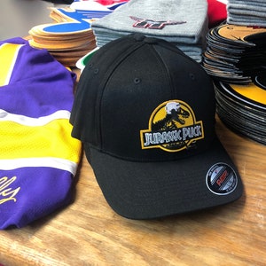 Black FlexFit Hat with a Jurassic Puck Embroidered Twill Crest