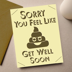 May include: A light yellow get well soon card with the text "Sorry You Feel Like" above a smiling poop emoji and "Get Well Soon" below. A brown envelope is in the background.