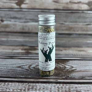 May include: A small glass bottle with a silver lid filled with dried herbs. The label reads "Scorpio Moon Ritual Wishing Powder Magick Blend 20ml".