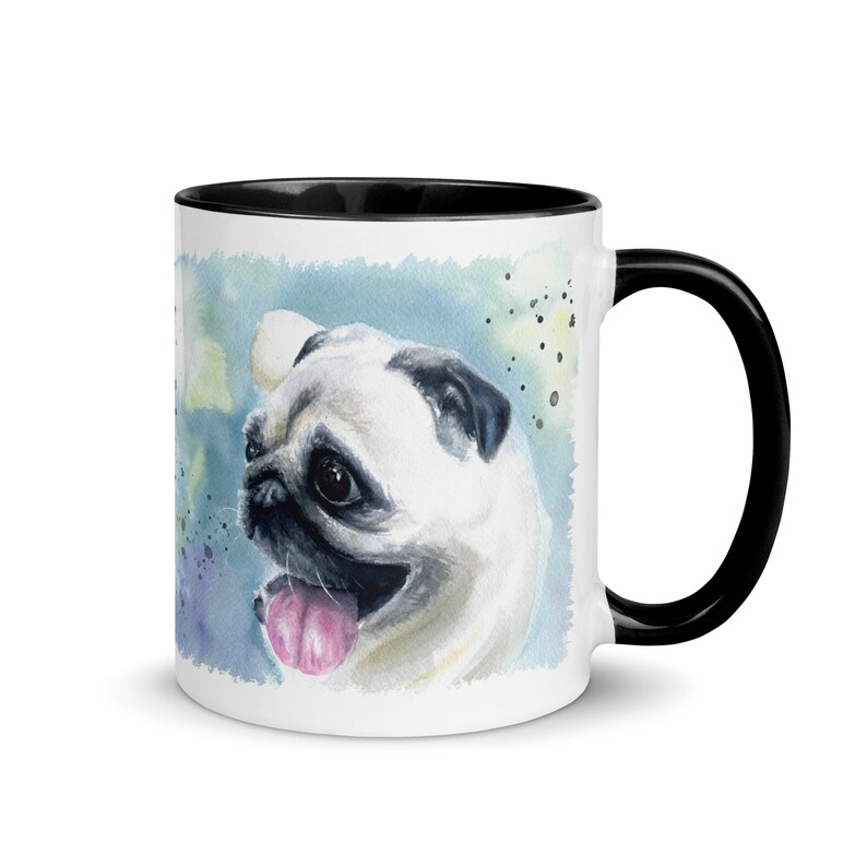 May include: White ceramic mug with a black rim and handle. The mug features a watercolor painting of a pug with a light blue background.