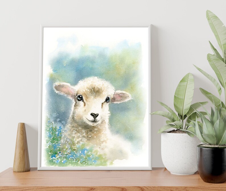 May include: A watercolor painting of a white lamb with blue eyes, looking directly at the viewer. The lamb is surrounded by blue flowers and a soft, green background.