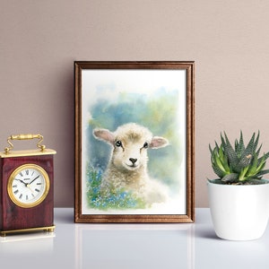 May include: A watercolor painting of a white lamb with black eyes and a light blue background. The lamb is surrounded by blue flowers.