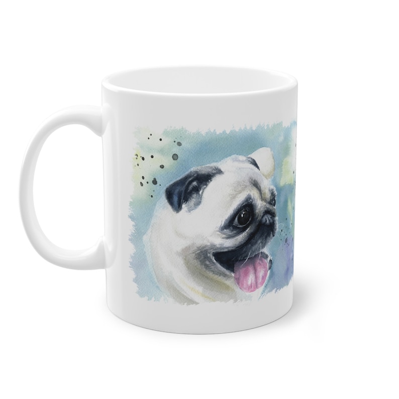 May include: White ceramic mug with a watercolor illustration of a pug dog with a pink tongue sticking out. The background is a blue and green watercolor wash.