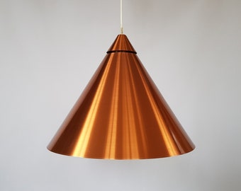May include: A copper cone-shaped pendant light fixture hangs from a white ceiling.
