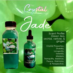 May include: Two bottles of green liquid with labels that say "The Crystal Collection Jade". The larger bottle is a bubble bath and the smaller bottle is a body oil. The scent profile is green tea, orchid, vetiver, and ginger. The crystal properties are stability, longevity, serenity, wisdom, tranquility, balance, peace, harmony, and perspective.