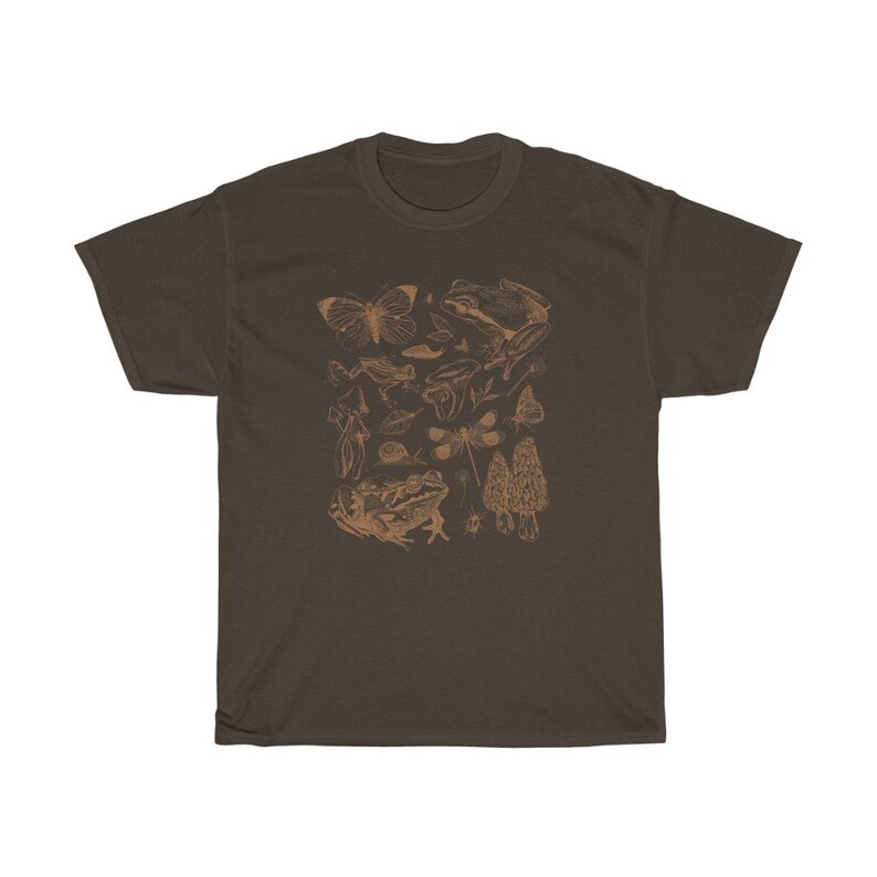 May include: A brown t-shirt with a print of various forest creatures, including frogs, butterflies, mushrooms, and dragonflies. The print is in a light brown color.