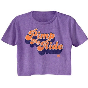 May include: Purple cropped t-shirt with a retro-style graphic that says "Pimp My Ride" in orange and blue lettering.