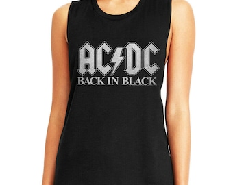 May include: Black sleeveless shirt featuring the band name "AC/DC" in silver block letters with a lightning bolt graphic. Below the band name is the text "BACK IN BLACK" in silver. The shirt is a classic rock and roll style.