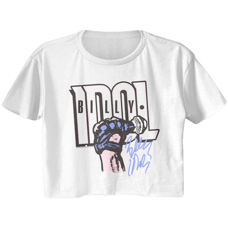 May include: White cropped t-shirt with a black and white graphic of a microphone and the text "BILLY IDOL". The graphic is in a retro style and includes a blue and white hand holding the microphone. The text "BILLY IDOL" is in a bold, black font. The shirt has a cropped hem and short sleeves.