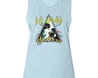 May include: A light blue sleeveless shirt with a graphic print of Def Leppard's "Hysteria" album cover. The graphic features a black and white image of a person with a microphone in a triangle with yellow, pink, and blue accents.
