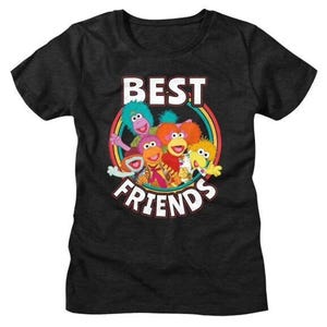 May include: Dark gray t-shirt featuring a colorful graphic of cartoon characters inside a rainbow circle. The text "BEST FRIENDS" is above and below the characters in white, outlined in red. The shirt is a crew neck.