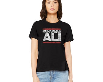 May include: Black t-shirt with a white graphic that says "Muhammad Ali" in a red box.