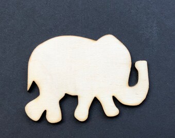 May include: A wooden cutout of an elephant in a light brown color. The elephant is standing on a black background.