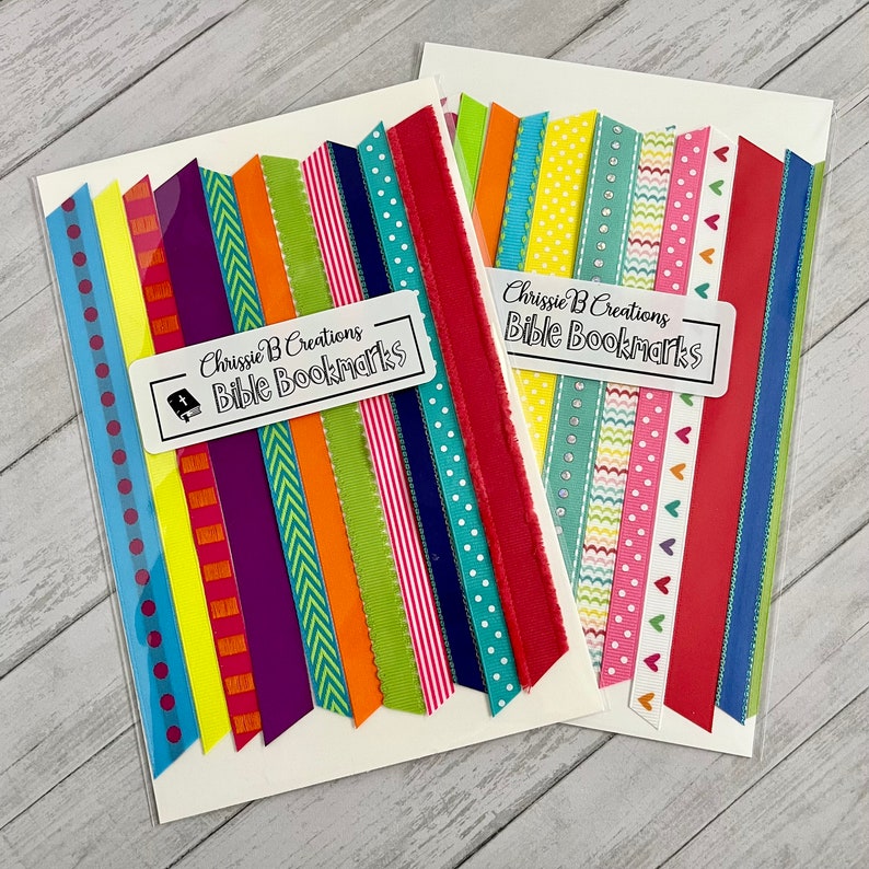 May include: Two sets of colorful ribbon bookmarks with the text "Chrissie B Creations Bible Bookmarks" on each set.