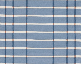 May include: A rectangular rug with a blue background and a grid pattern. The grid is formed by horizontal white stripes and vertical stripes in a darker blue color. Small brown squares connect the vertical and horizontal lines.