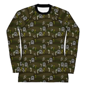May include: A long-sleeved shirt with a green, brown and white camouflage pattern featuring skulls and tombstones with the text "RIP".