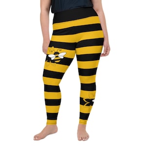 May include: Black and yellow striped leggings with a bee design. The leggings are high-waisted and have a comfortable fit.