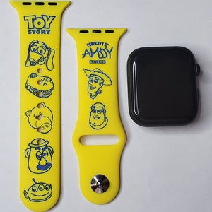 May include: Yellow silicone Apple Watch band with blue Toy Story characters, including Woody, Buzz Lightyear, and Slinky Dog. The band says "Property of Andy Est. 1995" and "Toy Story".