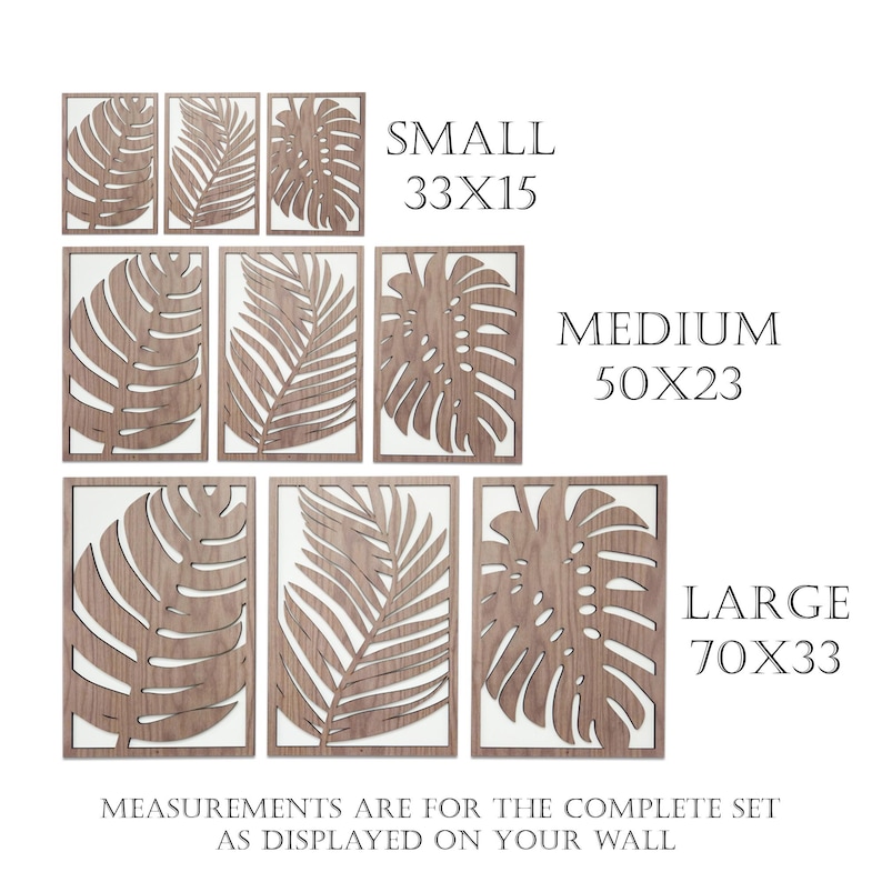May include: Set of three wood wall decor pieces featuring cut-out tropical leaf designs. The pieces are available in three sizes: small (33 x 15 inches), medium (50 x 23 inches), and large (70 x 33 inches).